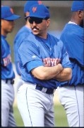 A baseball player with his arms crossed

Description automatically generated