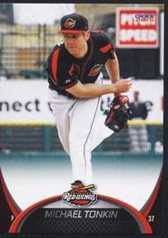 A baseball player in a red and black uniform

Description automatically generated